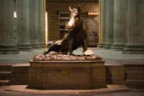 ITALY, Tuscany, Florence, The 17th century bronze fountain called Il Porcellino in the Mercato Nuovo, the New Market, also known as the Straw Market. The snout of the bronze wild boar shines because o...