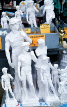 ITALY, Tuscany, Florence, Plaster souvenir statues of David by Michelangelo on a street stall.