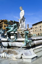 ITALY, Tuscany, Florence, The 1575 Mannerist Neptune fountain with the Roman sea God surrounded by water nymphs commemorating Tuscan naval victories by Ammannatti in the Piazza della Signoria beside t...