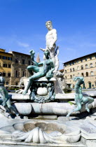 ITALY, Tuscany, Florence, The 1575 Mannerist Neptune fountain with the Roman sea God surrounded by water nymphs commemorating Tuscan naval victories by Ammannatti in the Piazza della Signoria beside t...