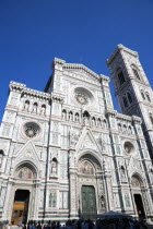 ITALY, Tuscany, Florence, The Neo-Gothic marble west facade of the Cathedral of Santa Maria del Fiore the Duomo and Giotto's Campanile bell tower and sightseeing tourists at the entrance.