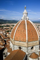 ITALY, Tuscany, Florence, The Dome of the Cathedral of Santa Maria del Fiore the Duomo by Brunelleschi with tourists on the viewing platform looking over the city towards the surrounding hills.