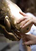 ITALY, Tuscany, Florence, The 17th century bronze fountain called Il Porcellino in the Mercato Nuovo also known as the Straw Market where the snout of the wild boar shines where people rub it under th...