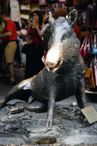 ITALY, Tuscany, Florence, The 17th century bronze fountain called Il Porcellino in the Mercato Nuovo also known as the Straw Market where the snout of the wild boar shines where people rub it under th...