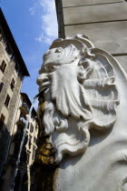 ITALY, Tuscany, Florence, Santa Croce District Drinking water fountain in the form of a male head on the corner of a street.