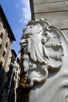 ITALY, Tuscany, Florence, Santa Croce District Drinking water fountain in the form of a male head on the corner of a street.