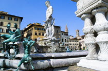 ITALY, Tuscany, Florence, The 1575 Mannerist Neptune fountain with the Roman sea God surrounded by water nymphs commemorating Tuscan naval victories by Ammannatti in the Piazza della Signoria beside t...