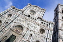 ITALY, Tuscany, Florence, The Neo-Gothic marble west facade of the Cathedral of Santa Maria del Fiore the Duomo and Giotto's Campanile bell tower.