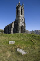 IRELAND, County Doneghal, Poisoned Glen, Ruined Church of Ireland building with gravestone in foreground. 
