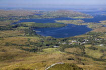 IRELAND, County Galway, Connemara, Diamond Hill, Ballynakill Harbour as seen from the slopes of the hill  Hikers at viewpoint. 