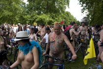 ENGLAND, London, Hyde Park, people with their bicycles, gathered together under the shade of the trees, waiting for the world naked bike ride protest parade to   start.