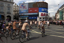 ENGLAND, London, Picadilly Circus, Naked people riding their bicycles while participating at the world naked bike ride protest parade.