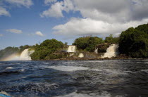 VENEZUELA, Bolivar State, Canaima National Park, Canaima Village, three waterfalls that feed into Canaima lake with blue sky and white clouds.