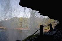 VENEZUELA, Bolivar State, Canaima National Park, Canaima Village, Waterfall waters creating a curtain effect while the forest and Canaima Lake are noticeable at the background, shoot from a path just...