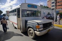 VENEZUELA, Margarita Island, Porlamar, Local route bus, old and in bad state, shoot at the streets of Porlamar on a bright sunny day with blue sky and white clouds.