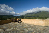 VENEZUELA, Margarita Island, La Asuncion, Canons at the terrace of Castillo de Santa Rosa fort facing the valley and the La Asuncion small town.