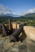 VENEZUELA, Margarita Island, La Asuncion, Canons at the terrace of Castillo de Santa Rosa fort facing the valley and the La Asuncion small town.