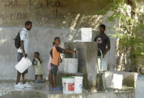 HAITI, Isla de la Laganave, children collecting clean drinking water.
