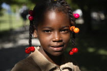 Dominican Republic, Samana Peninsula, Cayo Levantado, Barcardi Island, Portrait of local school girl with coloured beads in her hair.