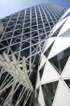 Japan, Tokyo, Shinjuku, New Cocoon Building, unusual shape and design, young couple coming out of entrance, dome attached to main building.