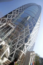 Japan, Tokyo, Shinjuku, Cocoon Building, unusual design, man walking by in front.