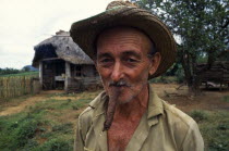 CUBA, Vinales, Pinar del Rio, Portrait of tobacco farmer smoking cigar.