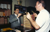 CUBA, Havana, Partagas Cigar factory shop.  Man paying for purchases with credit card. 