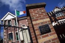 Ireland, North, Belfast, Andersonstown, James Connolly  House, Sinn Fein Headquarters with Irish Tricolour flag flying. memorial placque fro John Downes killed by RUC plastic bullet in 1984.