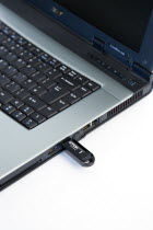 Industry, Computers, Components, 8 gigabyte USB portable flash storage device inserted into laptop USB port.