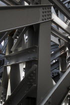 Japan, Tokyo, Kanda, under the JR train tracks, close up of the steel I beams and structure supporting the tracks.