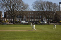 England, West Sussex, Southwick, Local Cricket team playing on village green.