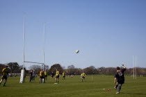 England, West Sussex, Shoreham-by-Sea, Rugby Teams playing on Victoria Park playing fields. Player kicking a conversionbetween the posts.