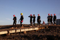 England, West Sussex, Goring-by-Sea, Worthing Triathlon 2009, female competitors making their way down slipway to swim starting point.