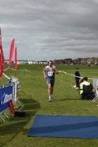 England, West Sussex, Goring-by-Sea, Worthing Triathlon 2009, male competitor approaching finish line.