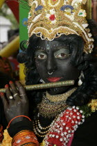 Religion, Hindu, Worship, London Rathayatra celebrations in Trafalgar Square. Person dressed as the God Lord Krishna with colourful sequins and bangles.