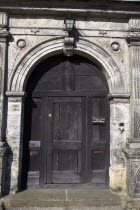 England, West Sussex, East Grinstead, wooden door of Sackville College a former Alms house built with sandstone.