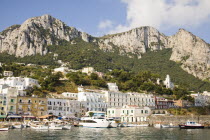 Italy, Campania, Capri, View of harbour, buildings and mountains from the sea, Marina Grande.