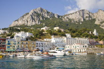 Italy, Campania, Capri, View of harbour, buildings and mountains from the sea, Marina Grande.