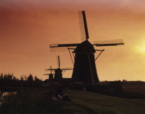 Holland, Zaanse Schans Mills, Windmill silhoeutted at sunset.