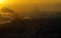 Russia, Moscow, Thick smoke from industrial chimneys hanging over the city at sunset.