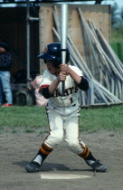 Japan, Honshu, Tako, Chiba, Little League baseball, young boy practising his batting swing.