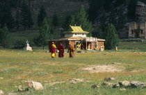 Mongolia, Kentii province, Baldan Baraivan, Monks walking through fields towards the temple.
