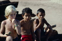 BrazilL, Para, Obidos, Children of different races eating Ingo Bau fruits.