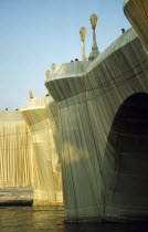 France, Ile de France, Paris, The Pont Neuf bridge across River Seine wrapped by the artist Christo as an installation sculpture.