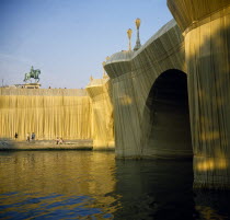 France, Ile de France, Paris, The Pont Neuf bridge across River Seine wrapped by the artist Christo as an installation sculpture.