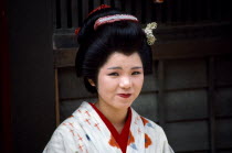 Japan, Honshu, Kyoto, Smiling female actress dressed in traditional costume of a Geisha in the Kyoto Movie Village home of the Samurai movies.