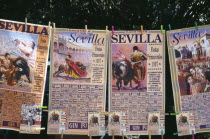 Spain, Andalucia, Seville, Posters and tickets for a bullfight hanging from a line outside the bullring in Arenal District.