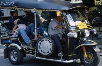 Thailand, North, Chiang Mai, Local family with young child as passengers in a Tuk Tuk three wheeled motorbike taxi.