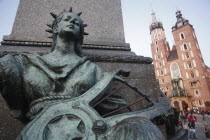Poland, Krakow, Detail of female figure on monument to the polish romantic poet Adam Mickiewicz by Teodor Rygier in 1898 in the Rynek Glowny market square with Mariacki Basilica or Church of St Mary i...