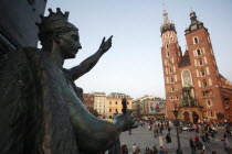 Poland, Krakow, Detail of female figure on monument to the polish romantic poet Adam Mickiewicz by Teodor Rygier in 1898 in the Rynek Glowny market square with Mariacki Basilica or Church of St Mary t...